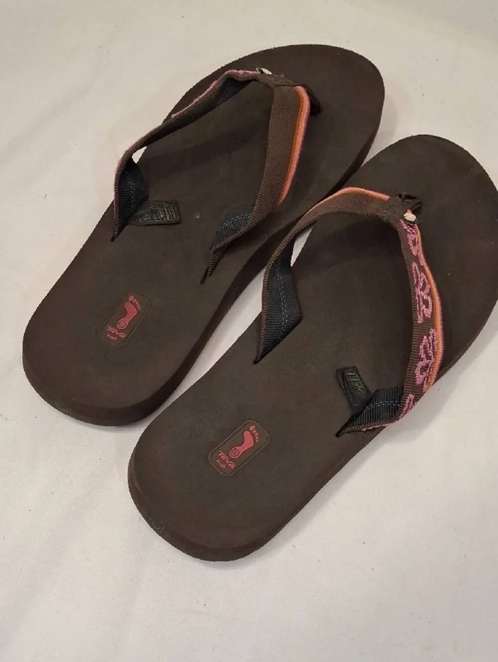Teva Men's Brown Thong Flip Flops with Mauve and Orange Accents.Lightly Worn
